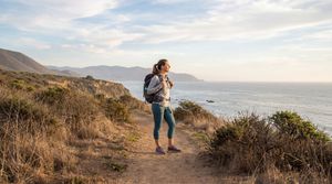 woman-hiking-staring-at-coast