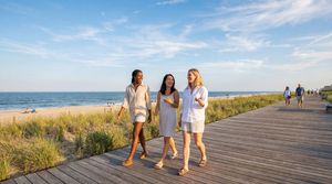 women-walking-at-sunny-beach